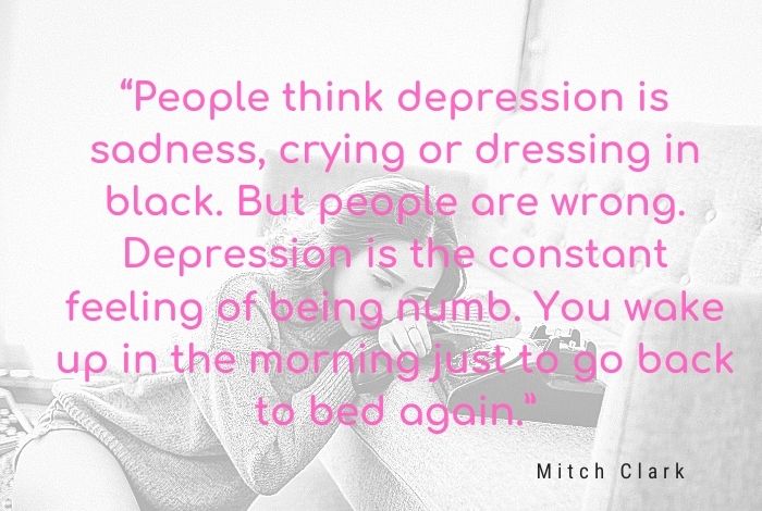 A person sitting alone with their head in their hands, symbolizing the weight of depression pressing down like an invisible anchor.